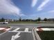 View of community green and playground, with residences visible in the background at 9787 Introduction Way, Orlando, FL 32832