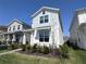 Inviting two-story home with manicured lawn and lush landscaping; great curb appeal at 9787 Introduction Way, Orlando, FL 32832