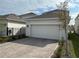 Paved driveway leading to a two-car garage in a residential neighborhood at 9787 Introduction Way, Orlando, FL 32832