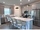 Spacious kitchen with gray cabinets, stainless steel appliances, and an island with seating for four at 9787 Introduction Way, Orlando, FL 32832