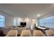 Bright and airy living room with a comfortable couch and a dining area with a wooden table at 9787 Introduction Way, Orlando, FL 32832