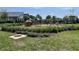 Charming community playground featuring a swing set and playhouse on a well-kept lawn at 9787 Introduction Way, Orlando, FL 32832