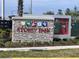The Story Park sign has an outdoor theme and is made of stone with various park-themed graphics at 9787 Introduction Way, Orlando, FL 32832