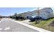 Street view of homes with paved driveways, and manicured lawns at 9787 Introduction Way, Orlando, FL 32832