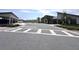 Street view of the community with paved roads and well-maintained landscaping at 9787 Introduction Way, Orlando, FL 32832