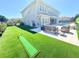 Beautiful backyard with artificial turf, a putting green, outdoor seating, and a view of the home's exterior at 10032 Brocksport Cir, Gotha, FL 34734