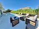 Backyard featuring a pool, outdoor seating, lush landscaping, and a fire pit for a relaxing outdoor experience at 10032 Brocksport Cir, Gotha, FL 34734