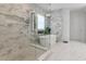 Spa-like bathroom with glass enclosed shower, soaking tub, elegant tile work, and abundant natural light at 10032 Brocksport Cir, Gotha, FL 34734