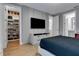 Stylish bedroom with an expansive closet for shoe storage, a modern TV, and a serene en-suite bathroom at 10032 Brocksport Cir, Gotha, FL 34734