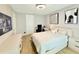 Bright bedroom with modern decor, featuring a cozy bed, sleek furniture, and ample lighting for a comfortable space at 10032 Brocksport Cir, Gotha, FL 34734