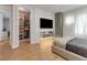 Well-organized bedroom with a walk-in closet, modern furnishings, and natural light at 10032 Brocksport Cir, Gotha, FL 34734
