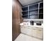 Built-in coffee bar with white cabinets, marble backsplash, open shelving, and decorative lighting, complete with appliances at 10032 Brocksport Cir, Gotha, FL 34734