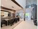 Modern dining room features an open floor plan, wine rack, and access to the living room, perfect for entertaining at 10032 Brocksport Cir, Gotha, FL 34734