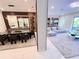 Bright, open-concept dining area with sleek table, wine rack, and seamless transition to the inviting living room at 10032 Brocksport Cir, Gotha, FL 34734