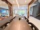 Contemporary dining room boasting a wine rack, modern lighting, and an open view into the living space at 10032 Brocksport Cir, Gotha, FL 34734