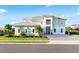 Beautiful two-story home showcasing a modern design, well-manicured lawn, and a paved driveway at 10032 Brocksport Cir, Gotha, FL 34734
