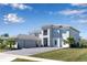 Stately home features a spacious three-car garage, lush lawn, and inviting facade with ample parking at 10032 Brocksport Cir, Gotha, FL 34734