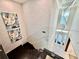 Elegant entryway with a modern staircase, artwork, and abundant natural light at 10032 Brocksport Cir, Gotha, FL 34734