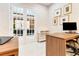 Bright home office with white french doors, a modern desk, and stylish wall art at 10032 Brocksport Cir, Gotha, FL 34734