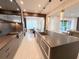 Modern kitchen with sleek countertops, stainless steel appliances, and a view into the dining and living areas at 10032 Brocksport Cir, Gotha, FL 34734