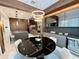 Modern kitchen and dining area with custom cabinets, stainless steel appliances, and large center island at 10032 Brocksport Cir, Gotha, FL 34734