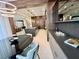 Modern kitchen and dining area with custom cabinets, stainless steel appliances, and center island with sink at 10032 Brocksport Cir, Gotha, FL 34734