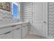 Bright laundry room featuring a white countertop, sink, cabinets, and a window offering natural light at 10032 Brocksport Cir, Gotha, FL 34734