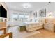 Bright main bedroom features a plush bed, modern decor, and large windows offering a view of the neighborhood at 10032 Brocksport Cir, Gotha, FL 34734