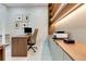 Modern office with wooden desk, shelves and decorative wall art creating an inspiring and productive workspace at 10032 Brocksport Cir, Gotha, FL 34734