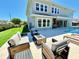 Inviting outdoor patio featuring a cozy seating area with fire pit, artificial grass and access to the pool at 10032 Brocksport Cir, Gotha, FL 34734
