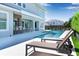 Relax by the beautiful pool with sun loungers and a covered patio, ideal for enjoying outdoor living and entertaining at 10032 Brocksport Cir, Gotha, FL 34734