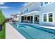 Enjoy this stunning backyard oasis with a private pool, outdoor bar and dining area, perfect for relaxing and entertaining at 10032 Brocksport Cir, Gotha, FL 34734
