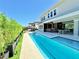 A stunning backyard with a private pool, covered outdoor dining, and a built-in bar area perfect for entertaining guests at 10032 Brocksport Cir, Gotha, FL 34734