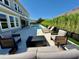 A stunning backyard featuring a sleek pool, comfortable lounge chairs, lush bamboo, and inviting outdoor seating area at 10032 Brocksport Cir, Gotha, FL 34734