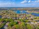 An arrow points to a lovely home near a scenic lake within a lush, green neighborhood at 1187 Tadsworth Ter, Lake Mary, FL 32746