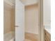 Bathroom featuring tiled bathtub with white door leading to an additional room at 1187 Tadsworth Ter, Lake Mary, FL 32746