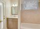 Bathroom featuring modern vanity, decorative mirror, and tiled shower at 1187 Tadsworth Ter, Lake Mary, FL 32746