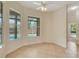 A sunny breakfast nook with tiled floor, ceiling fan, and window view of the pool area at 1187 Tadsworth Ter, Lake Mary, FL 32746
