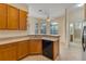 Open kitchen featuring wooden cabinetry and a breakfast nook overlooking backyard at 1187 Tadsworth Ter, Lake Mary, FL 32746