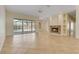 Spacious living room with tile floors, a fireplace, and sliding glass doors leading to a screened in pool at 1187 Tadsworth Ter, Lake Mary, FL 32746