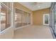 Covered patio with neutral colored floor, ceiling fan and view of the outdoor pool at 1187 Tadsworth Ter, Lake Mary, FL 32746