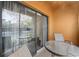 Screened-in balcony with furniture and sliding glass doors to the indoor living area at 12527 Floridays Resort Dr # E-111, Orlando, FL 32821