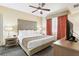 Well-appointed bedroom with a king-size bed, ceiling fan, and stylish window treatments at 12527 Floridays Resort Dr # E-111, Orlando, FL 32821