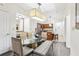 Chic dining area adjacent to a functional kitchen with a glass top table at 12527 Floridays Resort Dr # E-111, Orlando, FL 32821