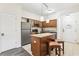 Efficient kitchen with an island, stainless steel appliances, and adjacent dining space at 12527 Floridays Resort Dr # E-111, Orlando, FL 32821