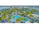 Aerial view showcasing a resort-style pool with palm trees, lounge chairs, and blue umbrellas for relaxing by the water at 13059 Stoddart Ave, Orlando, FL 32827