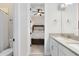 Modern bathroom with double sinks and view to the bedroom with a ceiling fan at 13059 Stoddart Ave, Orlando, FL 32827