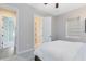 Bright bedroom featuring a bed and access to the hall and bathroom at 13059 Stoddart Ave, Orlando, FL 32827
