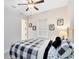 Charming bedroom with a plaid bedspread, ceiling fan, and delightful décor at 13059 Stoddart Ave, Orlando, FL 32827