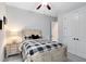 Bright bedroom featuring a queen bed with a ceiling fan and dresser at 13059 Stoddart Ave, Orlando, FL 32827
